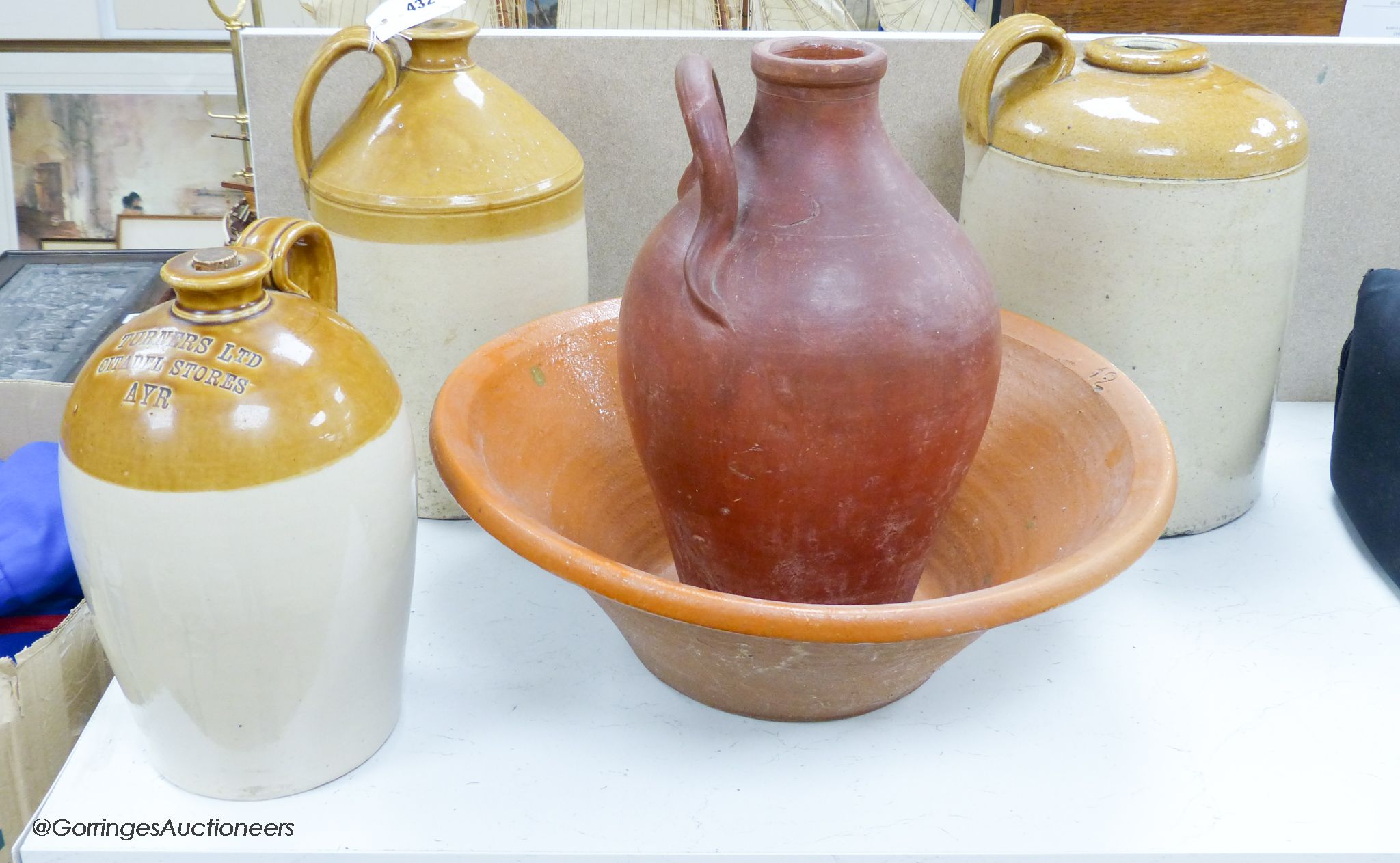 Stoneware flagons and a terracotta dairy bowl
